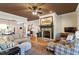 Inviting living room featuring a stone fireplace, hardwood floors, and comfortable furnishings at 3120 A Timberlyne Dr, Mebane, NC 27302