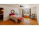 Well-lit main bedroom with hardwood floors, a comfortable bed, and large window at 3120 A Timberlyne Dr, Mebane, NC 27302