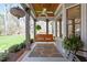Inviting covered porch features a swing, ceiling fan, and detailed woodwork at 3120 A Timberlyne Dr, Mebane, NC 27302