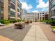 Community courtyard featuring outdoor seating, landscaping, and modern architectural building views at 319 Fayetteville St # 207, Raleigh, NC 27601