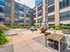 Beautifully landscaped community courtyard featuring lounge chairs, tables, greenery, and a modern sculpture at 319 Fayetteville St # 207, Raleigh, NC 27601