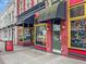 Street view of shops with colorful awnings, windows, and brick facades at 319 Fayetteville St # 207, Raleigh, NC 27601