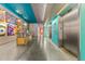 Hallway view features elevators, reception desk, concrete floors, and colorful walls at 319 Fayetteville St # 207, Raleigh, NC 27601