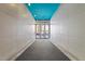 Entryway with gray walls, blue ceiling, and glass doors leading to the outside at 319 Fayetteville St # 207, Raleigh, NC 27601