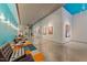 Gallery hallway featuring artwork, seating and pops of blue color at 319 Fayetteville St # 207, Raleigh, NC 27601