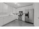 Modern kitchen featuring stainless steel appliances, track lighting and white cabinets at 319 Fayetteville St # 207, Raleigh, NC 27601