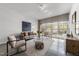 Bright living room with concrete floors, neutral palette, and large window at 319 Fayetteville St # 207, Raleigh, NC 27601