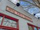 Rustic brick restaurant with vintage signage and overhead lighting at 319 Fayetteville St # 207, Raleigh, NC 27601