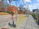 Street view with scooter and bike racks near red brick buildings at 319 Fayetteville St # 207, Raleigh, NC 27601