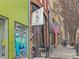View of the lively street featuring storefronts, American flags, and outdoor seating in an urban setting at 319 Fayetteville St # 207, Raleigh, NC 27601
