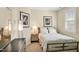 Cozy bedroom features a full-size bed, stylish decor, and window at 4 Teahouse Ct, Durham, NC 27707