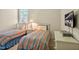 Bright bedroom has two twin beds with striped comforters and a television at 4 Teahouse Ct, Durham, NC 27707
