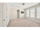 Large bedroom with neutral carpet, shuttered windows, and a television at 4 Teahouse Ct, Durham, NC 27707
