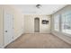 Spacious bedroom with neutral carpet, shuttered windows, and multiple doors at 4 Teahouse Ct, Durham, NC 27707