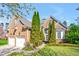 Charming brick home with manicured lawn and two-car garage, offering curb appeal at 4 Teahouse Ct, Durham, NC 27707