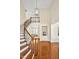 Grand foyer with hardwood floors, curved staircase, and elegant chandelier creates a welcoming entrance at 4 Teahouse Ct, Durham, NC 27707
