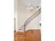 Elegant foyer features a curved staircase with dark iron spindles and hardwood floors at 4 Teahouse Ct, Durham, NC 27707