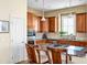 Gourmet kitchen features custom cabinets, stainless appliances, granite counters and a gas cooktop island at 4 Teahouse Ct, Durham, NC 27707
