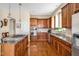 Gourmet kitchen featuring custom cabinets, granite countertops, stainless appliances, and gas cooktop island at 4 Teahouse Ct, Durham, NC 27707