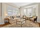 Cozy living room with plush seating, large windows, and a decorative area rug at 4 Teahouse Ct, Durham, NC 27707