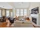 Inviting living area boasts fireplace, with lots of natural light and views into an open dining area at 4 Teahouse Ct, Durham, NC 27707