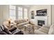 Cozy living room featuring a fireplace, large windows, and comfortable seating arrangement on top of a decorated rug at 4 Teahouse Ct, Durham, NC 27707