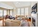 Bright living room with fireplace, large windows and hardwood floors that flows into an open dining area at 4 Teahouse Ct, Durham, NC 27707