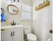 Charming half bath featuring a round mirror, stylish lighting, and welcome sign at 4532 Draper Rd, Raleigh, NC 27616