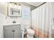 Bathroom with a shower and tub, bright lighting and updated fixtures at 4532 Draper Rd, Raleigh, NC 27616