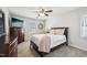 Cozy bedroom with a ceiling fan, tv, chest of drawers and comfortable bed at 4532 Draper Rd, Raleigh, NC 27616