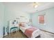 Bedroom with a vanity, comfortable bed, and decoratively appointed walls at 4532 Draper Rd, Raleigh, NC 27616