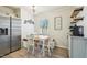 Bright breakfast nook with table, bench, chairs, and a view of the backyard at 4532 Draper Rd, Raleigh, NC 27616