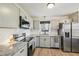 Modern kitchen featuring gray cabinets, stainless steel appliances, and granite countertops at 4532 Draper Rd, Raleigh, NC 27616