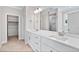 Bright bathroom featuring double vanity, white cabinetry, and a walk-in shower with glass enclosure at 4893 Grosbeak Ct, Mebane, NC 27302