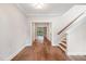 Bright foyer featuring hardwood floors, neutral walls, and a staircase with a wooden handrail at 4893 Grosbeak Ct, Mebane, NC 27302
