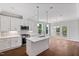 Modern kitchen featuring white cabinets, stainless steel appliances, and a center island with pendant lighting at 4893 Grosbeak Ct, Mebane, NC 27302