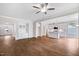 Spacious living room featuring hardwood floors, built-in shelving, and open access to the kitchen at 4893 Grosbeak Ct, Mebane, NC 27302