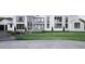 Stunning modern home with large windows, lush green lawn, and a beautifully landscaped driveway at 4900 Foxridge Dr, Raleigh, NC 27614