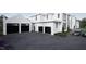 Spacious three-car garage with modern black doors and a paved driveway, complementing the home's exterior at 4900 Foxridge Dr, Raleigh, NC 27614