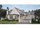 Home exterior featuring multi-car garages, grey roof, and manicured landscaping at 4921 Foxridge Dr, Raleigh, NC 27614