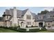 An elegant home with a stone exterior, arched entry and professionally landscaped front yard at 4921 Foxridge Dr, Raleigh, NC 27614
