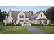Charming exterior with a grey roof, a manicured lawn, and a private driveway at 4921 Foxridge Dr, Raleigh, NC 27614