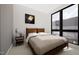 A minimalist bedroom features large windows, a comfortable bed and modern decor for a serene retreat at 512 Gordon St # 402, Durham, NC 27701