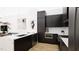 Modern kitchen with a large island with a white countertop, dark cabinets and stainless steel appliances at 512 Gordon St # 402, Durham, NC 27701