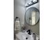 The bathroom has modern fixtures and a circular mirror at 512 Texas Ave, Burlington, NC 27217