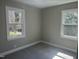 This bedroom features carpet flooring and two windows with natural light at 512 Texas Ave, Burlington, NC 27217