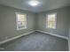 This bedroom features carpet flooring and two windows with natural light at 512 Texas Ave, Burlington, NC 27217