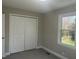 This bedroom features carpet flooring, closet, and a window with natural light at 512 Texas Ave, Burlington, NC 27217