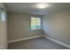 Carpeted bedroom with neutral walls and a bright window at 512 Texas Ave, Burlington, NC 27217