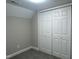 Carpeted bedroom featuring a closet with paneled doors at 512 Texas Ave, Burlington, NC 27217